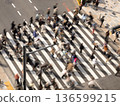 A crosswalk with many pedestrians passing by in Tokyo 136599215