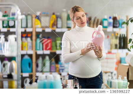 Pregnant woman choosing eco-friendly detergent in supermarket Pregnant woman choosing eco-friendly detergent in supermarket 136599227