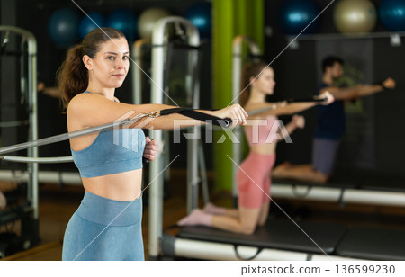 Young woman doing exercises on pilates class Young woman doing exercises on pilates class 136599230