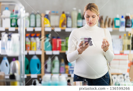 Pregnant woman shopping for scented candles for cozy atmosphere at home Pregnant woman shopping for scented candles for cozy atmosphere at home 136599266