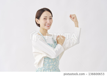 Woman wearing an apron, motivated gesture, white background Woman wearing an apron, motivated gesture, white background 136600653