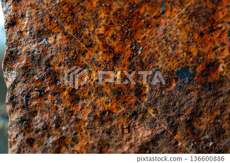 Close-up of rusty metal surface with weathered texture and rich brown-orange hues 136600886