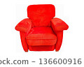Red plush armchair with cushioned support on black background 136600916
