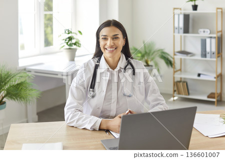 Portrait Of Happy Woman Doctor Or Nurse Working In Clinic Office Portrait Of Happy Woman Doctor Or Nurse Working In Clinic Office 136601007