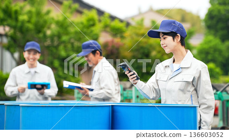 A group of workers inspecting drums 136603052