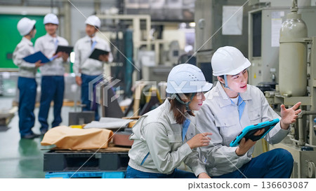Group of workers working in a factory Group of workers working in a factory 136603087