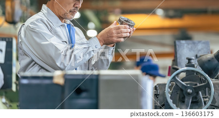 Male worker inspecting products at a factory Male worker inspecting products at a factory 136603175