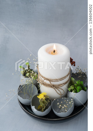 Easter holiday decoration from sustainable materials egg shell decor with candle. Copy space Diy do it yourself Gift present idea. Zero waste Crafting preparation Easter holiday decoration from sustainable materials egg shell decor with candle. Copy space Diy do it yourself Gift present idea. Zero waste Crafting preparation 136604002