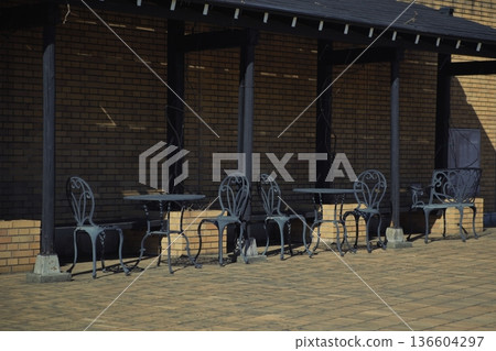 A lonely chair and table with no one around 136604297