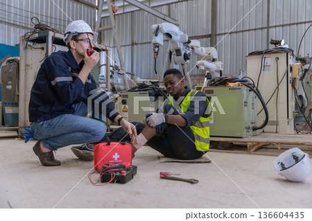 First aid support accident at work of worker at factory. First aid support accident at work of worker at factory. 136604435