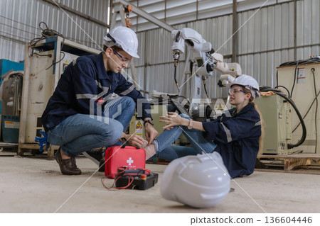 First aid support accident at work of worker at factory.  136604446