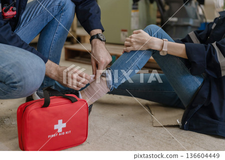 First aid support accident at work of worker at factory.  136604449