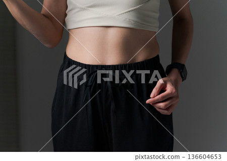 Part cut of a woman doing muscle training with dumbbells 136604653
