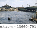 Vintage photo from 1932 in Tokyo, showing Ryogoku Bridge over the Sumida River and the Ryogoku Kokugikan Sumo Hall (black and white photo colorized using AI) 136604791