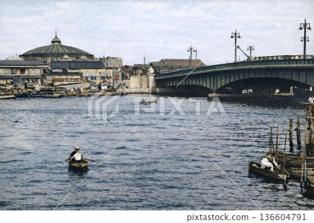 Vintage photo from 1932 in Tokyo, showing Ryogoku Bridge over the Sumida River and the Ryogoku Kokugikan Sumo Hall (black and white photo colorized using AI) 136604791