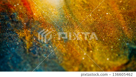 Blur sparkling texture. Colorful particles. Yellow orange blue shimmering stream. Glowing shiny abstract background ink powder flow. 136605462