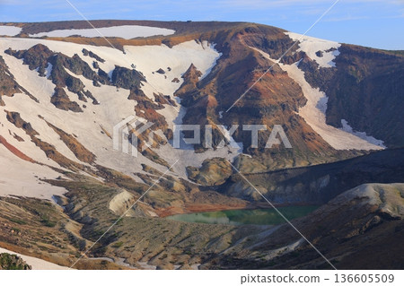 Snow still remains on the mountainside Snow still remains on the mountainside 136605509