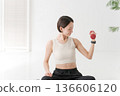 Women training on dumbbells 136606120