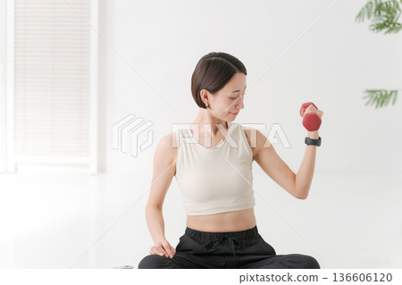 Women training on dumbbells 136606120