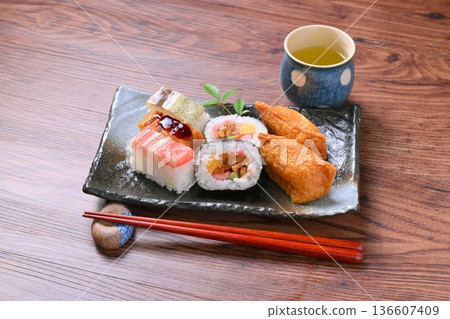 An assortment of inari sushi, inari sushi, thick rolls, and pressed sushi. An assortment of inari sushi, inari sushi, thick rolls, and pressed sushi. 136607409