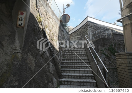A streetscape with stone-walled alleyways and Japanese-style architecture A streetscape with stone-walled alleyways and Japanese-style architecture 136607420