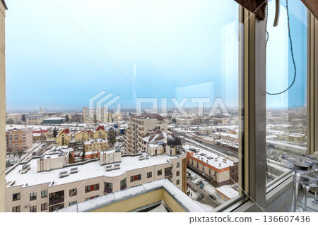 Snowy Winter Cityscape View from Modern Apartment Window 136607436