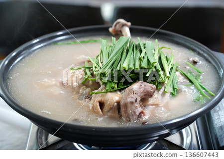 Healthy Korean Boiled Whole Chicken Soup Baeksuk with Fresh Chives in a Traditional Pot 136607443
