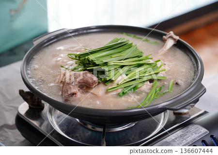 Healthy Korean Boiled Whole Chicken Soup Baeksuk with Fresh Chives in a Traditional Pot Healthy Korean Boiled Whole Chicken Soup Baeksuk with Fresh Chives in a Traditional Pot 136607444