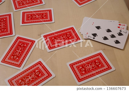 Playing cards laid out on a wooden table Playing cards laid out on a wooden table 136607673