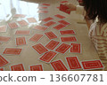 A child seriously choosing a playing card 136607781