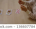 A child arranging his cards at the end of a card game 136607784