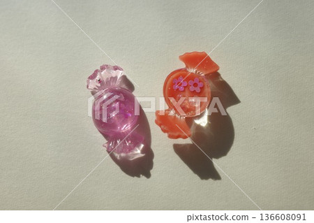 Candy-shaped resin parts and shadows 136608091