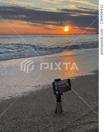Shooting on the beach at sunset. High quality photo Shooting on the beach at sunset. High quality photo 136608411