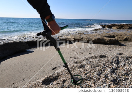 Beach metal detecting. High quality photo 136608958