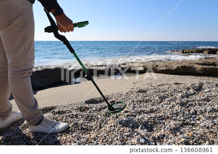 Beach metal detecting. High quality photo 136608961