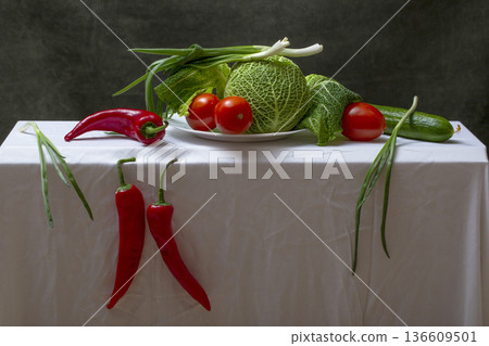 Still life with Savoy cabbage, vegetables and fruits on a white tablecloth 136609501