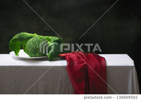 Still life with Savoy cabbage on a white tablecloth. Still life with Savoy cabbage on a white tablecloth. 136609502