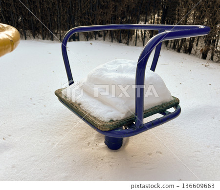 A children's chair under the snow 136609663