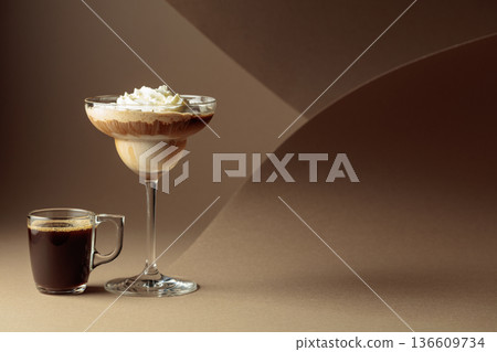 Black coffee and iced coffee cocktail on a beige background. Black coffee and iced coffee cocktail on a beige background. 136609734