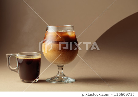 Black coffee and iced coffee cocktail on a beige background. Black coffee and iced coffee cocktail on a beige background. 136609735
