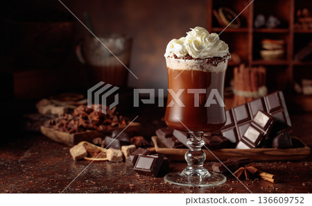 Hot chocolate with whipped cream in a glass mug. 136609752