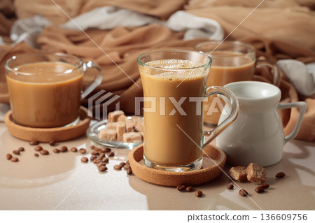 Latte with brown sugar on a beige background. 136609756