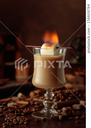 Cocktail of cream and coffee, decorated with a burning marshmallow. 136609764
