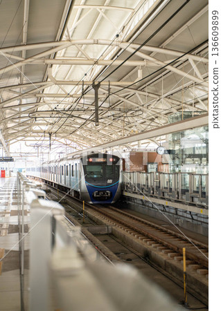 A train stopping at a Jakarta MRT station 136609899