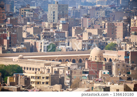 Dense Middle Eastern cityscape with historic mosque dome 136610180