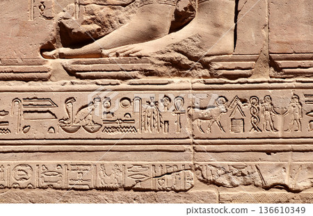 Ancient Egyptian hieroglyphs on stone wall, Karnak Temple Complex, Luxor, Egypt, Africa. Stone carvings with hieroglyphs at Karnak temple complex, Thebes Ancient Egyptian hieroglyphs on stone wall, Karnak Temple Complex, Luxor, Egypt, Africa. Stone carvings with hieroglyphs at Karnak temple complex, Thebes 136610349