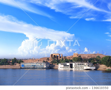 View from cruise ship on Nile river and Kom Ombo Temple, Egypt, Africa. Luxury Nile Cruise. Summer vacation, relaxing on cruise ship. Famous tourist attraction. Topic of travel, trip, cruises and tour 136610350