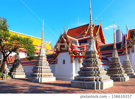 Stupas and ancient pavilion in Wat Pho (Temple of the Reclining Buddha, Wat Phra Chetuphon) complex, sightseeing landmark of Bangkok, Thailand. Topic of vacation, travel, trip, cruises, tour 136610357