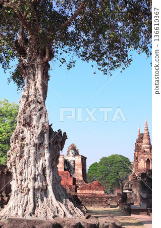 Ancient Buddha statue in Wat Mahathat Temple, Sukhothai historical park. Picturesque landscape with tree and stone stupa in Sukhothai old city, Northern Thailand. Topic of travel, trip, cruise, tour Ancient Buddha statue in Wat Mahathat Temple, Sukhothai historical park. Picturesque landscape with tree and stone stupa in Sukhothai old city, Northern Thailand. Topic of travel, trip, cruise, tour 136610367