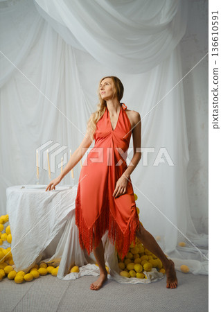 Model poses near lemons and candles at a creative studio in the afternoon Model poses near lemons and candles at a creative studio in the afternoon 136610591